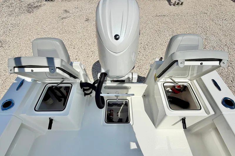 Slide: The Image of 2026 Bay Rider 219 Bay boat with open storage compartments and engine view. - 33
