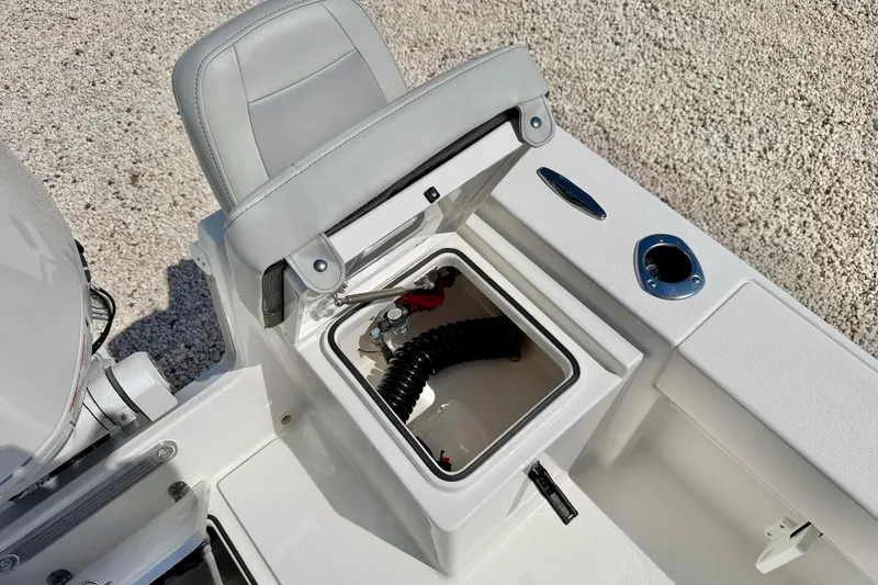 Slide: The Image of 2026 Bay Rider 219 Bay boat storage compartment with open lid and seating. - 35