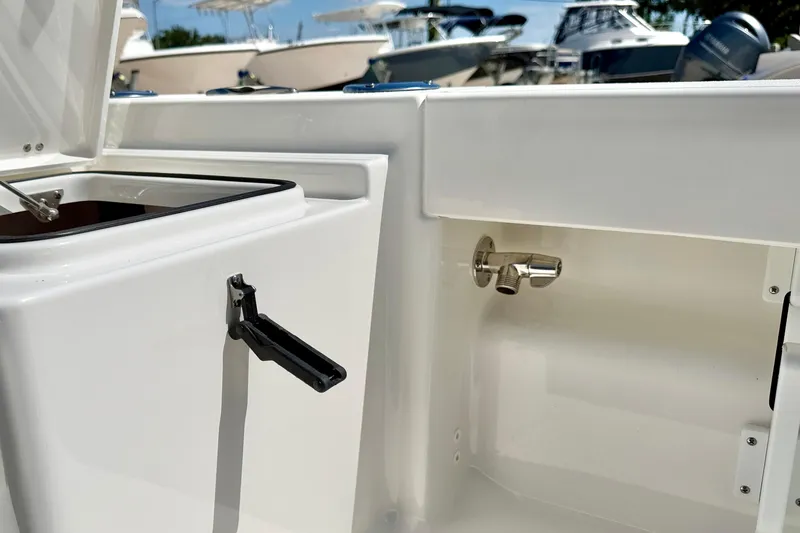 Slide: The Image of 2026 Bay Rider 219 Bay boat interior with storage compartment and faucet detail. - 36