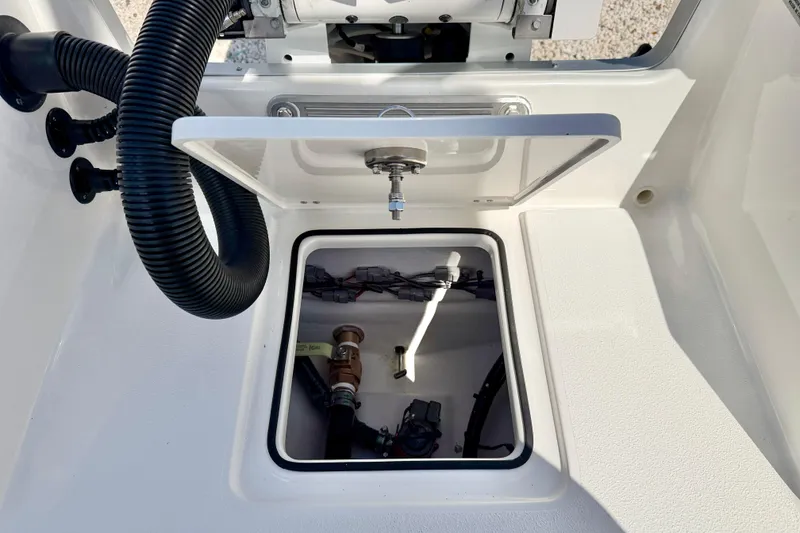 Slide: The Image of 2026 Bay Rider 219 Bay boat compartment with open hatch and visible wiring. - 37