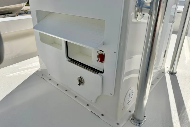 Slide: The Image of 2026 Bay Rider 219 Bay boat console with storage compartments and stainless steel railings. - 38