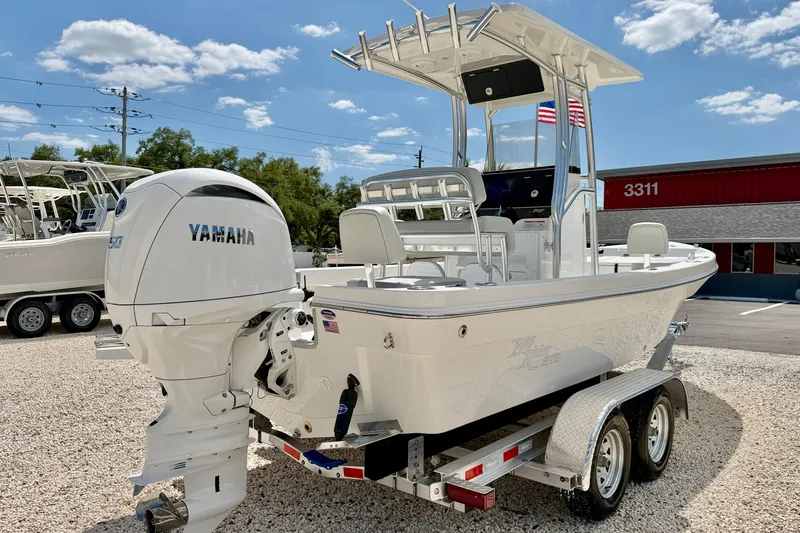 Slide: The Image of 2026 Bay Rider 219 Bay boat with Yamaha engine on a trailer, parked outdoors. - 5