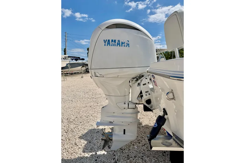 Slide: The Image of 2026 Bay Rider 219 Bay boat with Yamaha outboard motor in a sunny marina. - 50