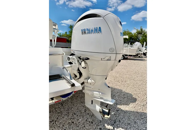 Slide: The Image of 2026 Bay Rider 219 Bay with Yamaha outboard motor on gravel lot. - 51