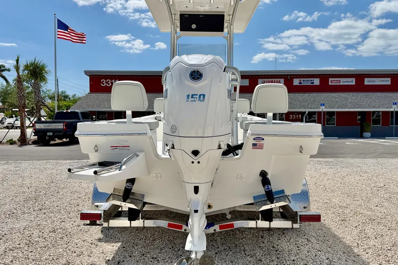 Slide: The Image of 2026 Bay Rider 219 Bay boat with 150 HP engine, parked outdoors. - 6