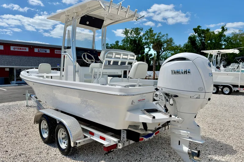 Slide: The Image of 2026 Bay Rider 219 Bay boat with Yamaha engine on trailer, outdoor dealership setting. - 7
