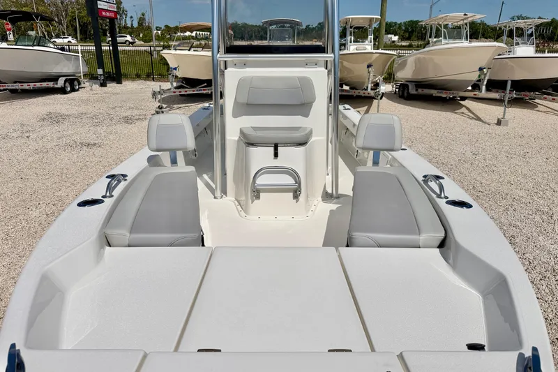 Slide: The Image of 2026 Bay Rider 219 Bay boat interior with seating and console, displayed outdoors. - 8