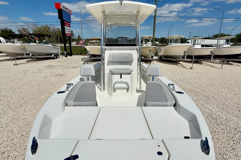 Slide: The Image of 2026 Bay Rider 219 Bay boat displayed in a dealership lot under a clear blue sky. - 9