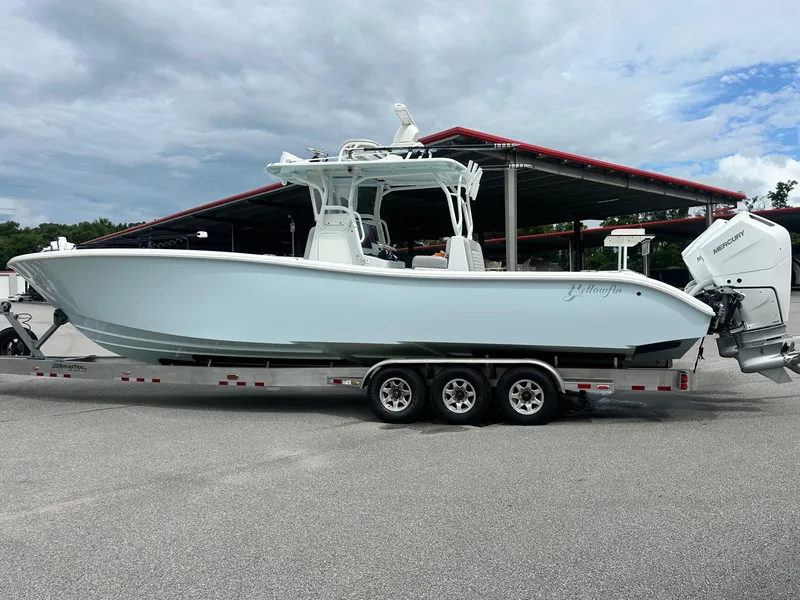 Slide: The Image of 2021 Yellowfin 36 Offshore boat on trailer, parked outdoors under cloudy sky. - 10