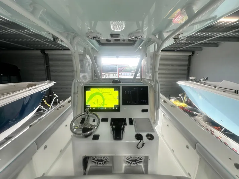 Slide: The Image of 2021 Yellowfin 36 Offshore boat cockpit with advanced navigation system and steering wheel. - 14