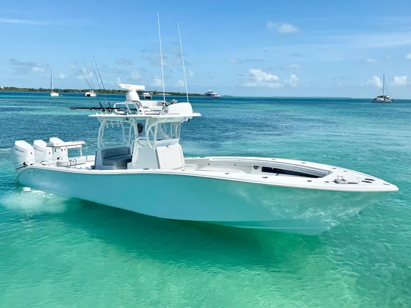 Slide: The Image of 2021 Yellowfin 36 Offshore boat cruising on clear turquoise waters. - 2
