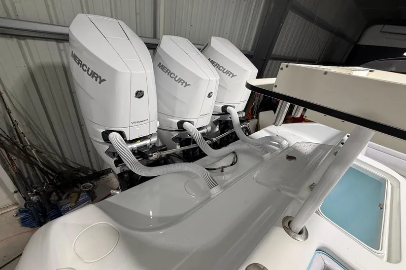 Slide: The Image of 2021 Yellowfin 36 Offshore boat with triple Mercury Verado outboard engines in a storage facility. - 22