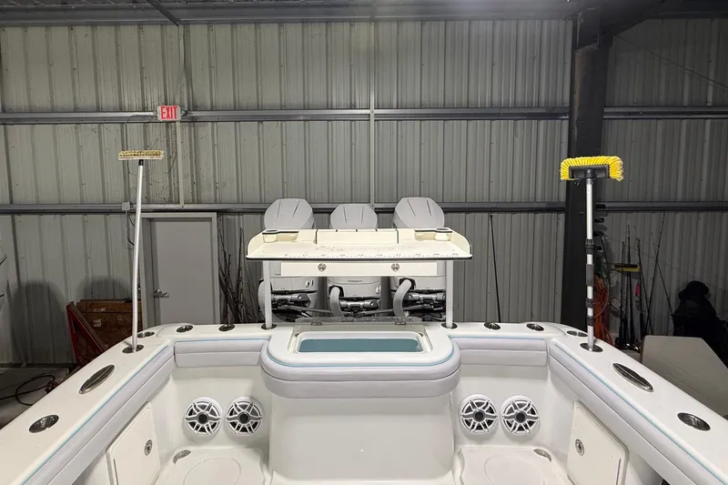 Slide: The Image of 2021 Yellowfin 36 Offshore boat interior with seating, storage, and fishing equipment in a garage. - 24