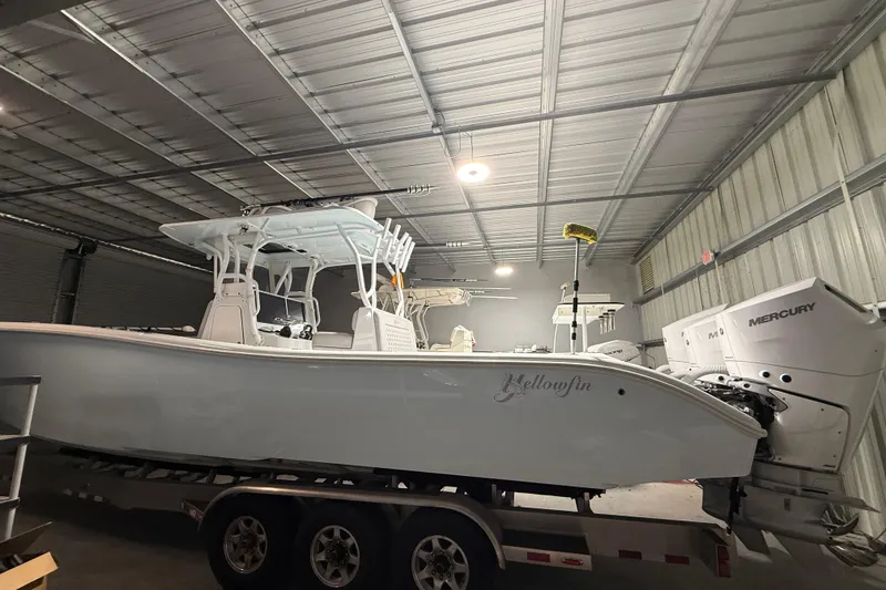 Slide: The Image of 2021 Yellowfin 36 Offshore boat in a garage, featuring Mercury engines. - 25