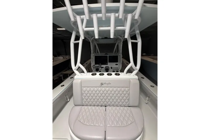 Slide: The Image of 2021 Yellowfin 36 Offshore boat interior with diamond-stitched seating and modern console. - 27