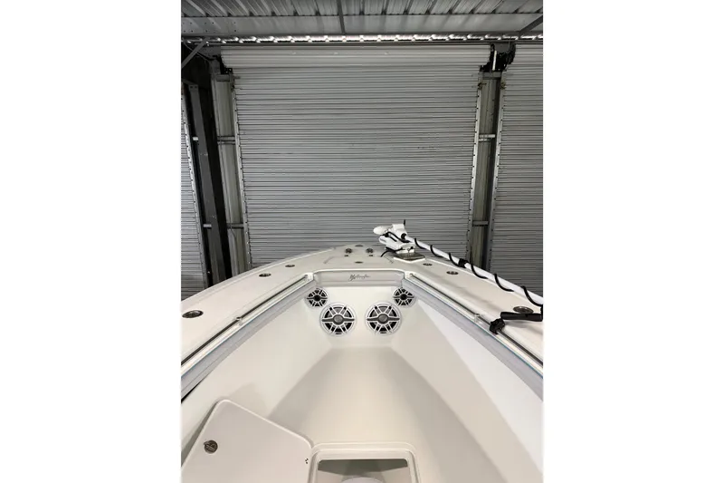 Slide: The Image of 2021 Yellowfin 36 Offshore boat interior with speakers and storage, in a garage setting. - 29