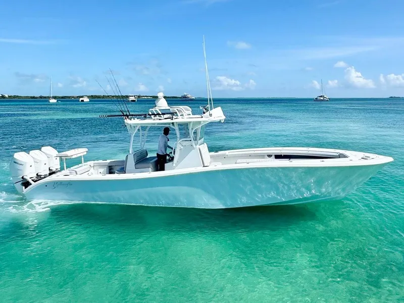 Slide: The Image of 2021 Yellowfin 36 Offshore boat cruising in clear turquoise waters under a blue sky. - 5