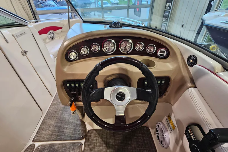 Slide: The Image of Dashboard of a 2000 Chaparral 230 SSi boat with steering wheel and gauges. - 11