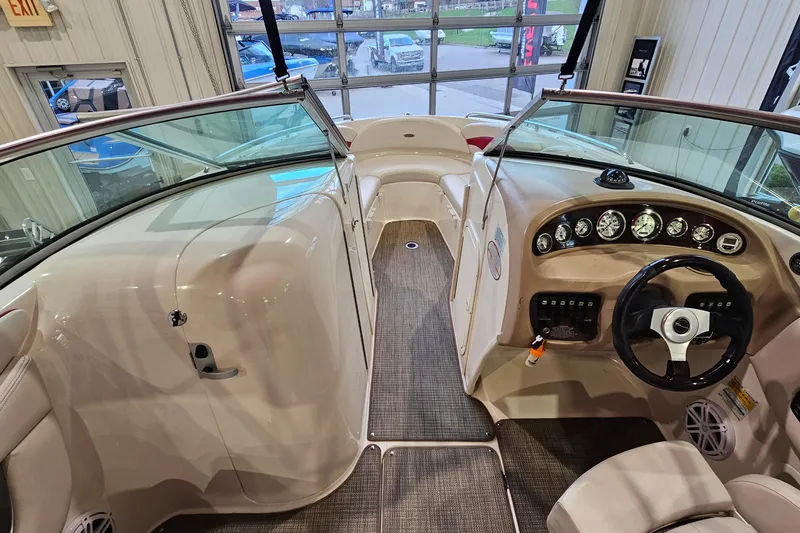 Slide: The Image of Interior view of a 2000 Chaparral 230 SSi boat, showcasing the helm and seating area. - 12