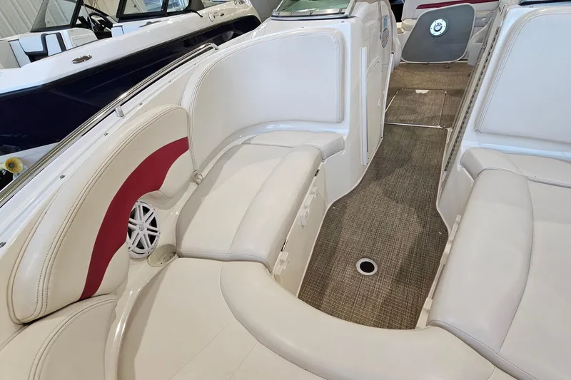 Slide: The Image of Interior of a 2000 Chaparral 230 SSi boat with white seating and red accents. - 17