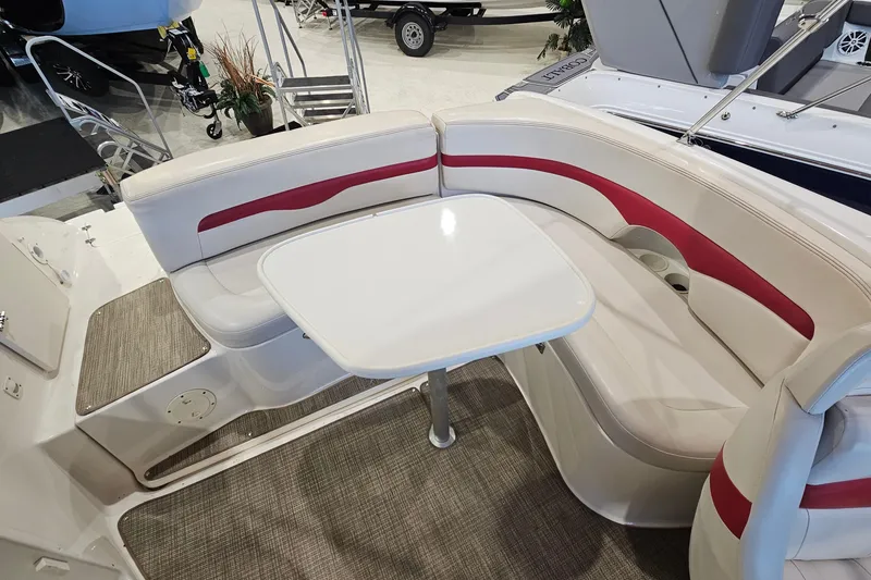 Slide: The Image of 2000 Chaparral 230 SSi boat interior with white and red seating and table. - 19