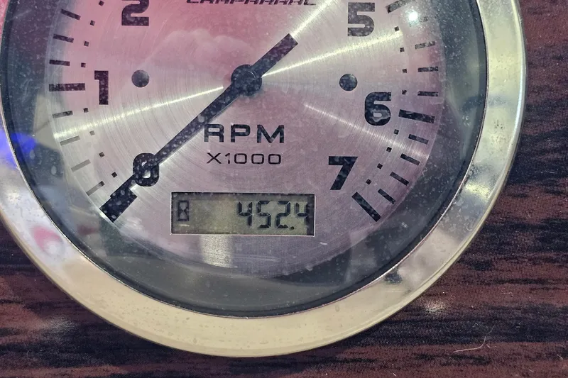 Slide: The Image of Close-up of a Chaparral 230 SSi 2000 RPM gauge displaying 452.4 hours. - 23