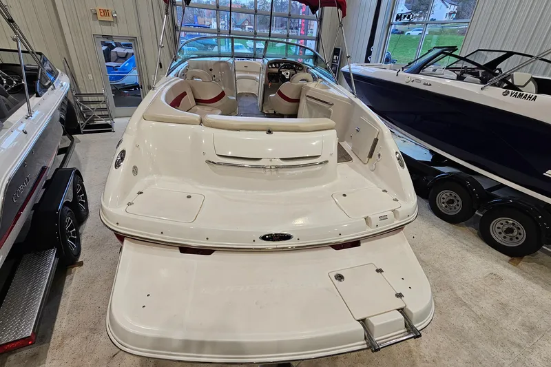 Slide: The Image of 2000 Chaparral 230 SSi boat displayed indoors, showcasing spacious seating and sleek design. - 4