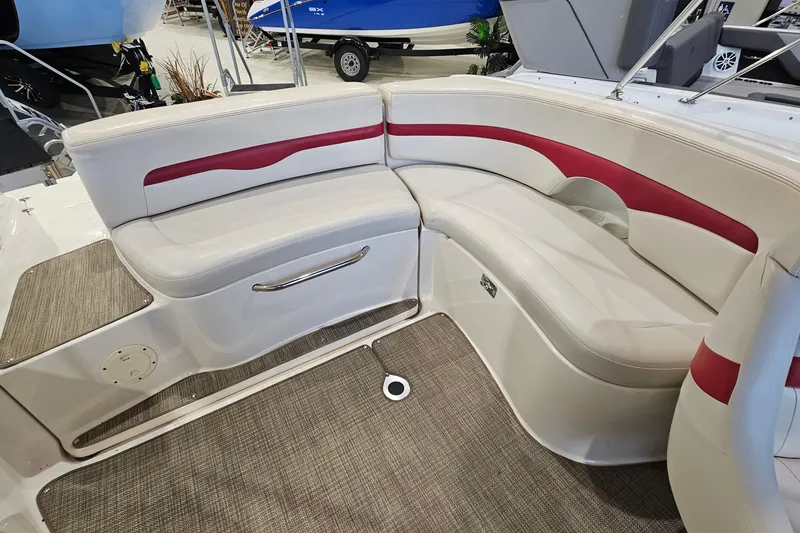 Slide: The Image of 2000 Chaparral 230 SSi boat interior with white and red cushioned seating. - 7