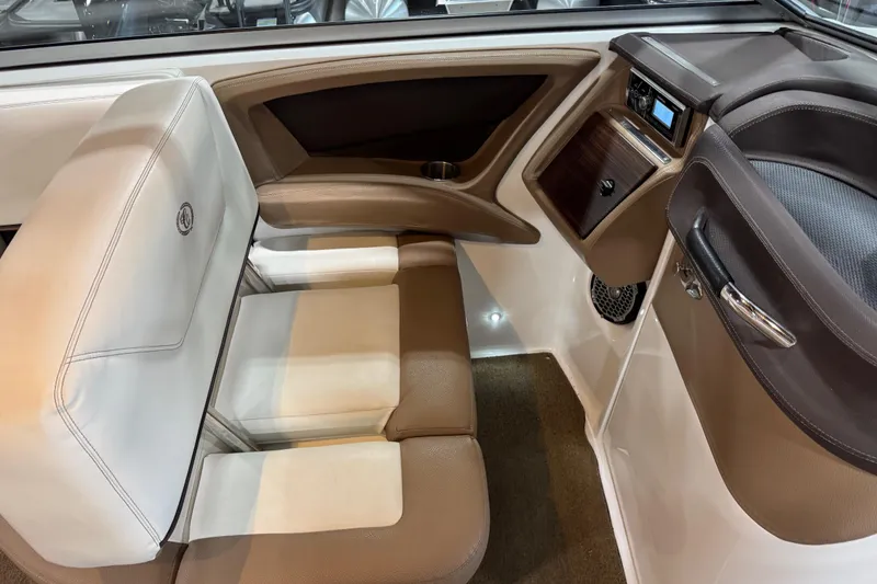 Slide: The Image of Interior of a 2015 Cobalt 302 boat with beige and white seating. - 12