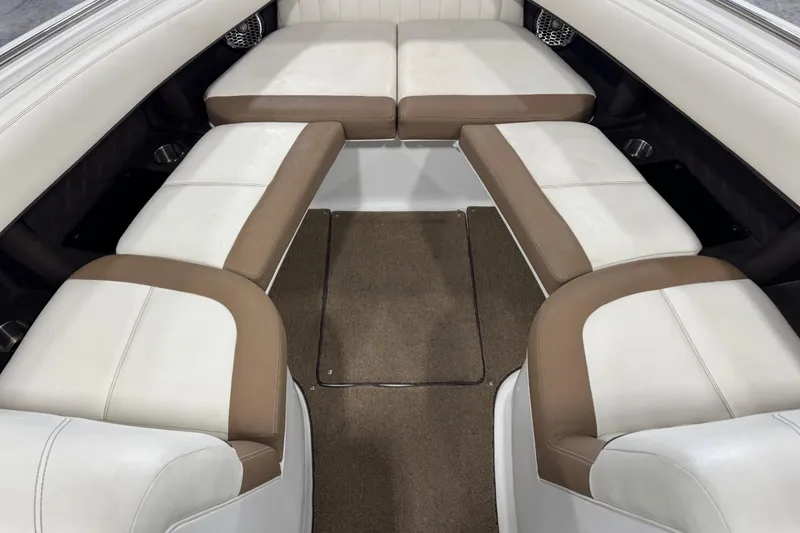 Slide: The Image of Interior seating of a 2015 Cobalt 302 boat with white and brown upholstery. - 13