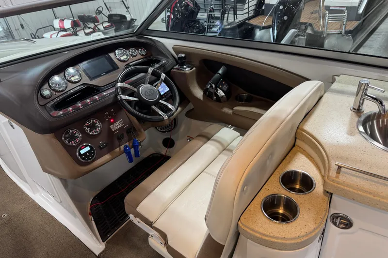 Slide: The Image of Interior of a 2015 Cobalt 302 boat featuring a sleek dashboard and modern amenities. - 15