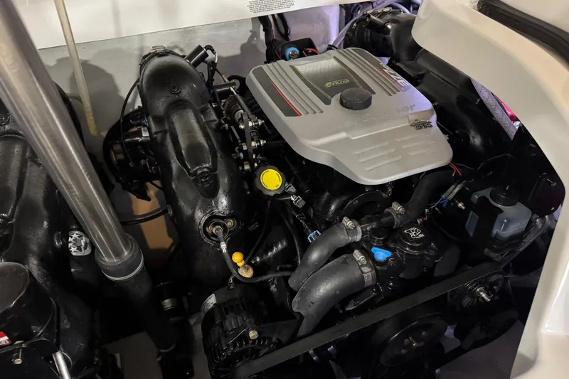 Slide: The Image of Engine compartment of a 2015 Cobalt 302 boat, featuring a MerCruiser engine. - 17
