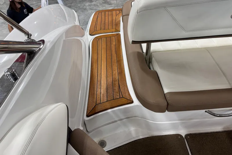 Slide: The Image of Interior of a 2015 Cobalt 302 boat with teak flooring and white seating. - 7