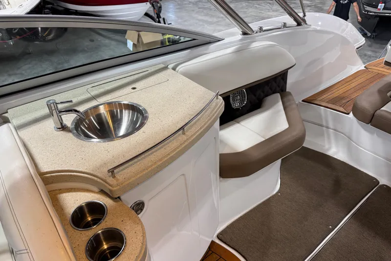 Slide: The Image of Interior of a 2015 Cobalt 302 boat featuring a sink and seating area. - 8