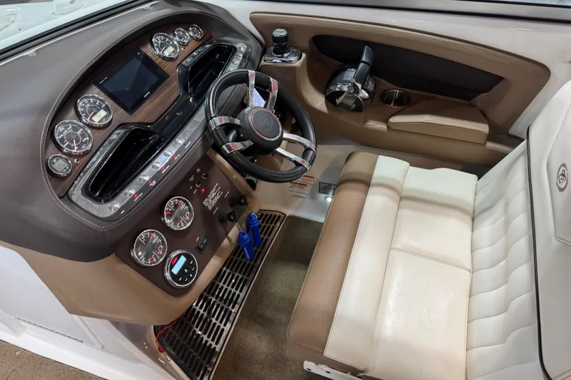 Slide: The Image of Cockpit of a 2015 Cobalt 302 boat with leather seating and modern dashboard controls. - 9