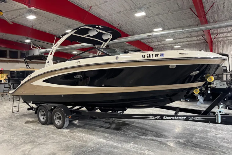 The Image of 2015 Sea Ray SDX 270 boat on trailer in indoor showroom. - 1