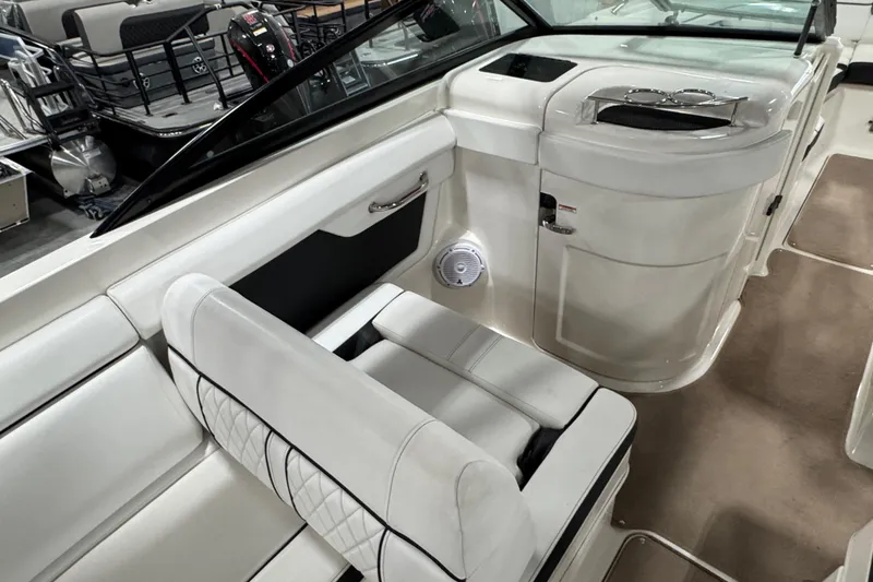 Slide: The Image of 2015 Sea Ray SDX 270 interior with white seating and sleek design. - 10
