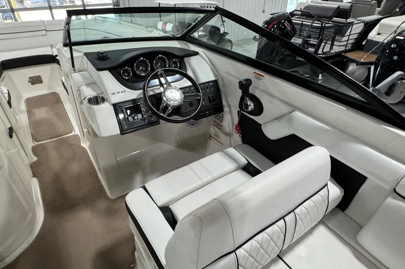 Slide: The Image of 2015 Sea Ray SDX 270 boat interior with steering wheel and seating. - 11