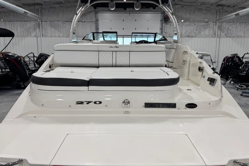 Slide: The Image of 2015 Sea Ray SDX 270 boat interior with white seating in a showroom. - 6