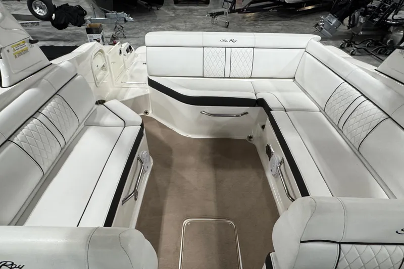 Slide: The Image of Interior of a 2015 Sea Ray SDX 270 boat with white seating and elegant design. - 7