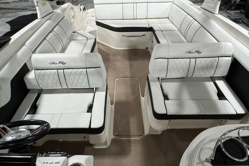Slide: The Image of Interior of a 2015 Sea Ray SDX 270 boat with luxurious white seating. - 8