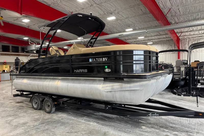 The Image of 2022 Harris Sunliner 230 pontoon boat on trailer in indoor showroom. - 1