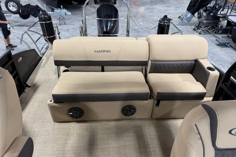 Slide: The Image of 2022 Harris Sunliner 230 boat interior with beige seating and integrated speakers. - 10