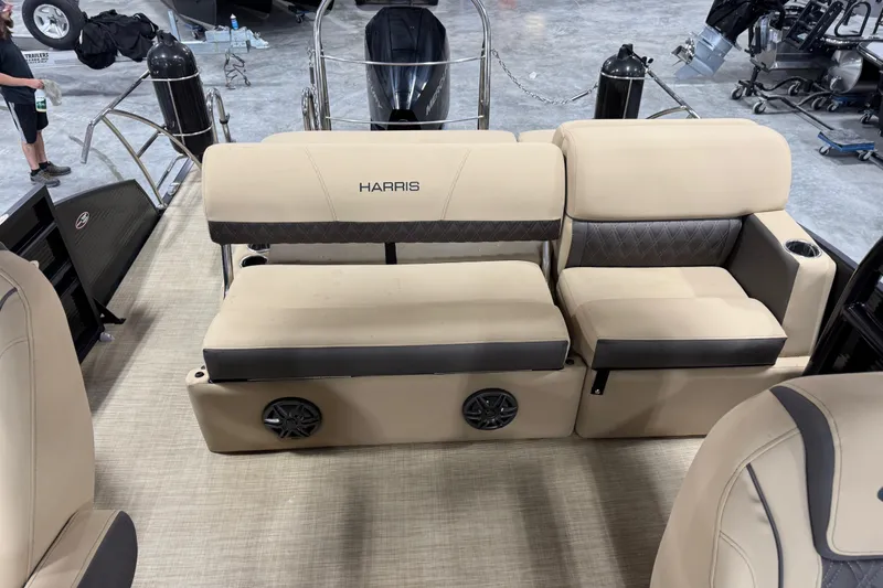 Slide: The Image of 2022 Harris Sunliner 230 boat interior with beige seating and speaker system. - 11