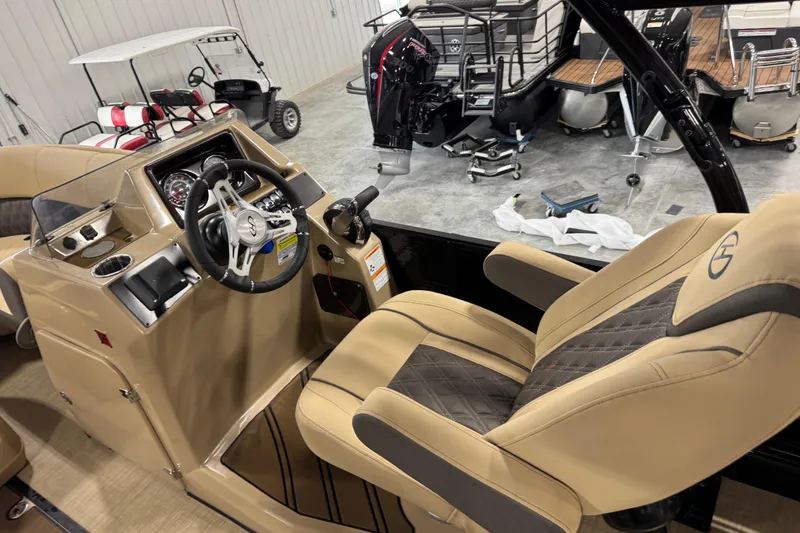 Slide: The Image of 2022 Harris Sunliner 230 boat interior with tan captain's chair and steering console. - 14