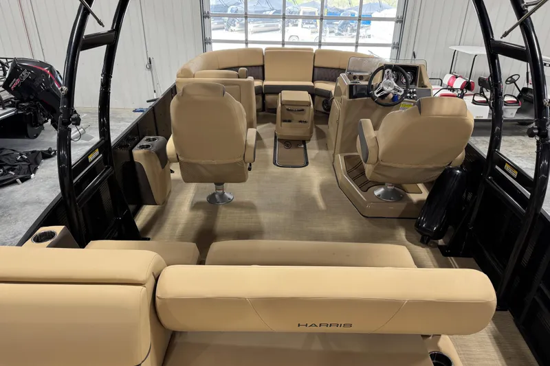 Slide: The Image of 2022 Harris Sunliner 230 boat interior with beige seating and modern helm. - 15