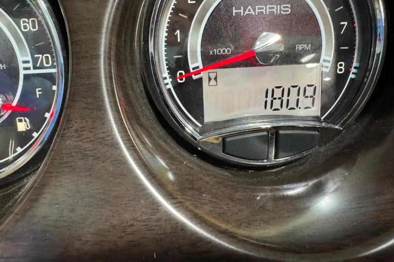 Slide: The Image of Close-up of Harris Sunliner 230 dashboard showing RPM gauge and digital display reading 180.9. - 17