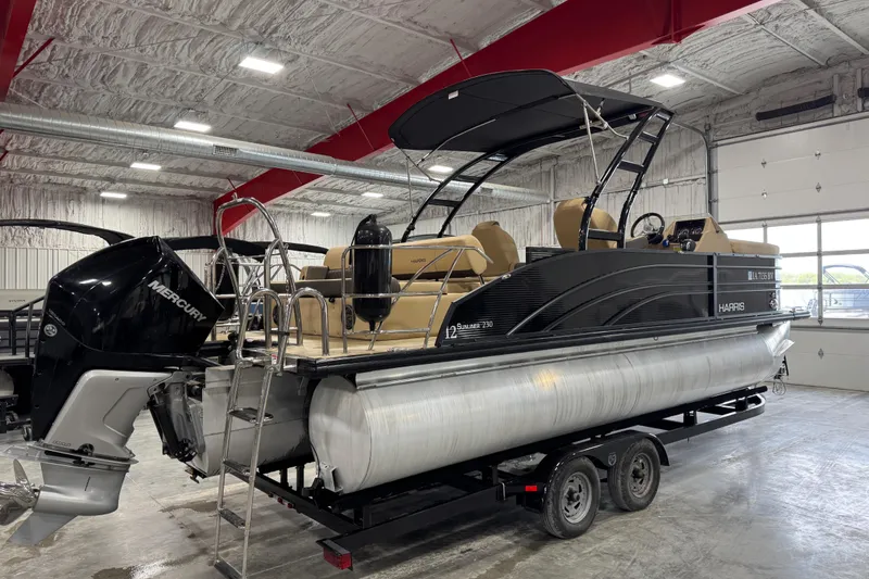 Slide: The Image of 2022 Harris Sunliner 230 pontoon boat with Mercury engine in a showroom. - 4