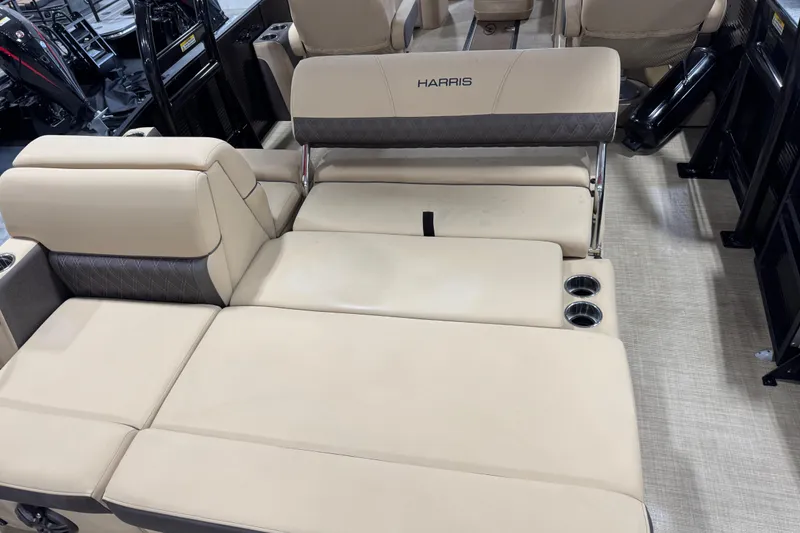 Slide: The Image of Luxurious seating on 2022 Harris Sunliner 230 pontoon boat with cup holders and beige upholstery. - 7