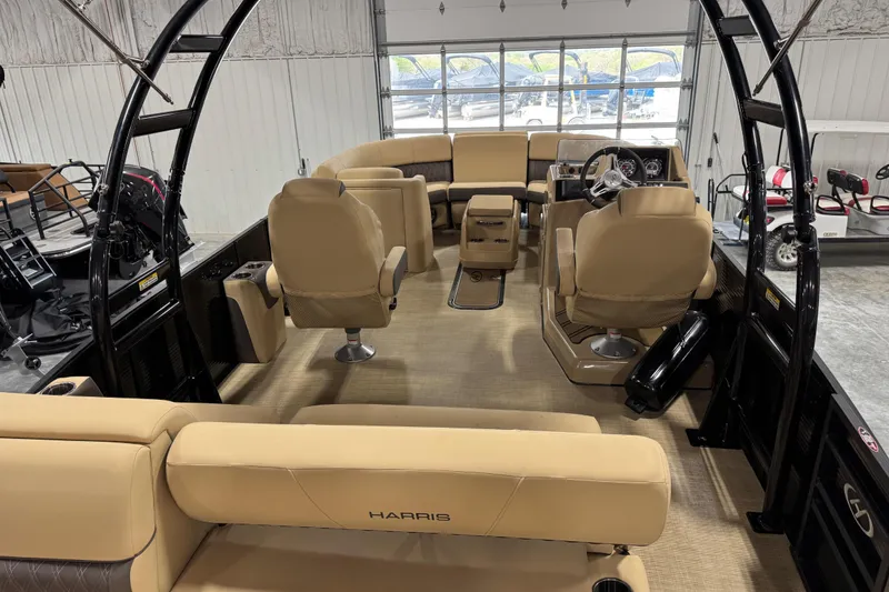 Slide: The Image of 2022 Harris Sunliner 230 boat interior with beige seating and modern dashboard. - 9